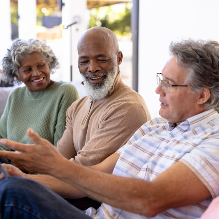 Caucasian senior man using digital pc while sitting with multira